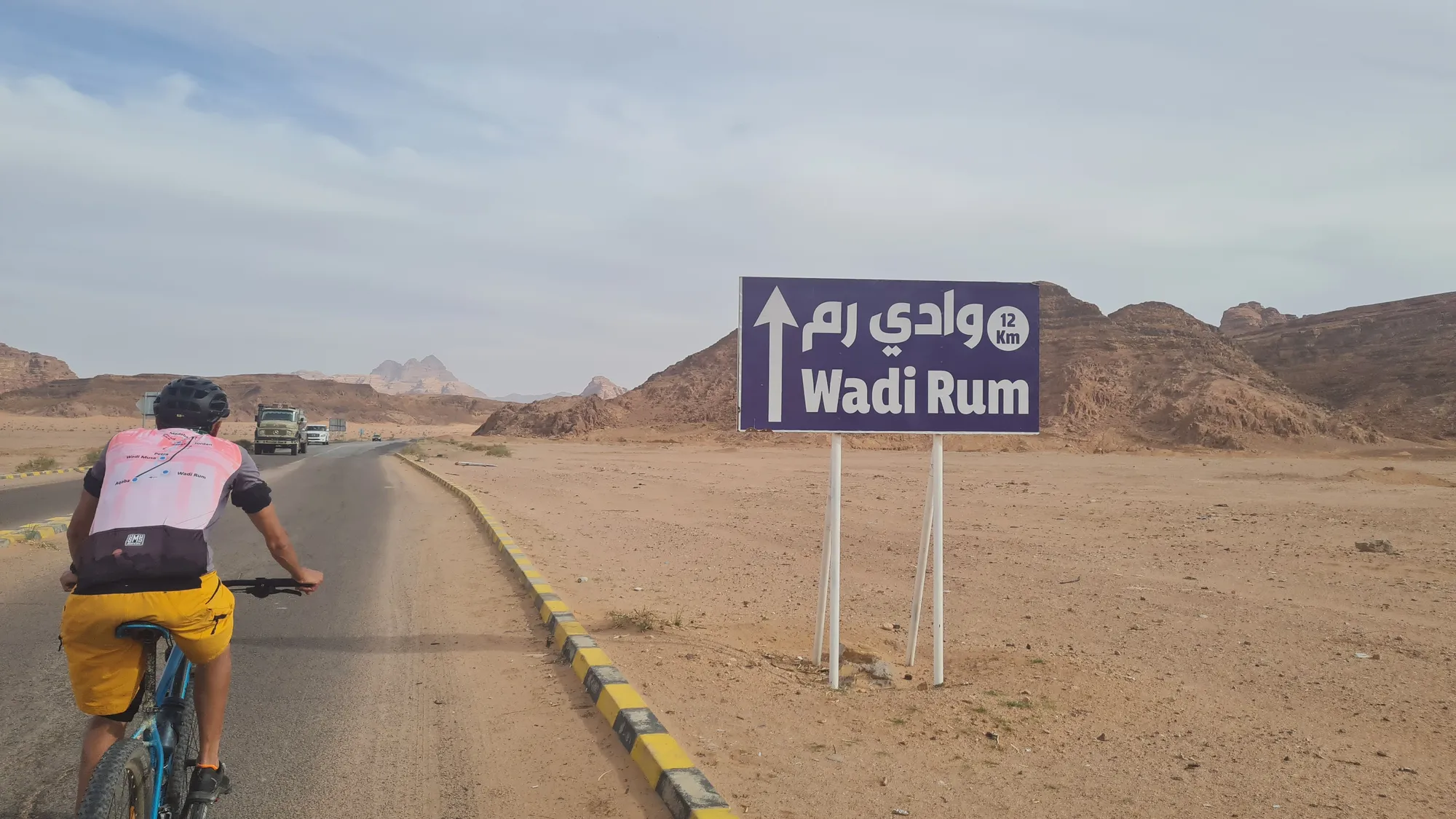 Cyclist at the sign to Wadi Rum