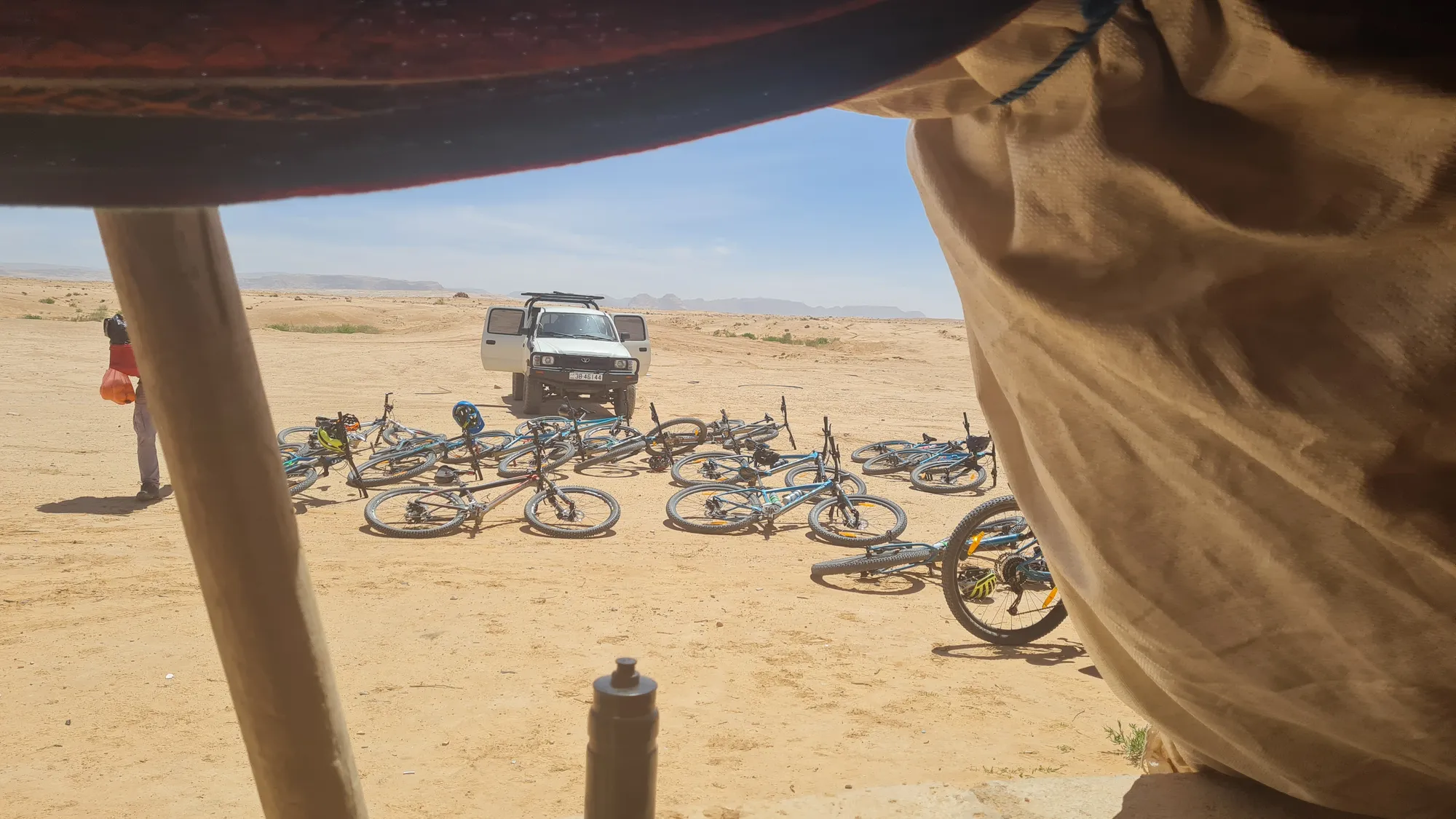 Lunch break in the shade, the bikes lying in the sand