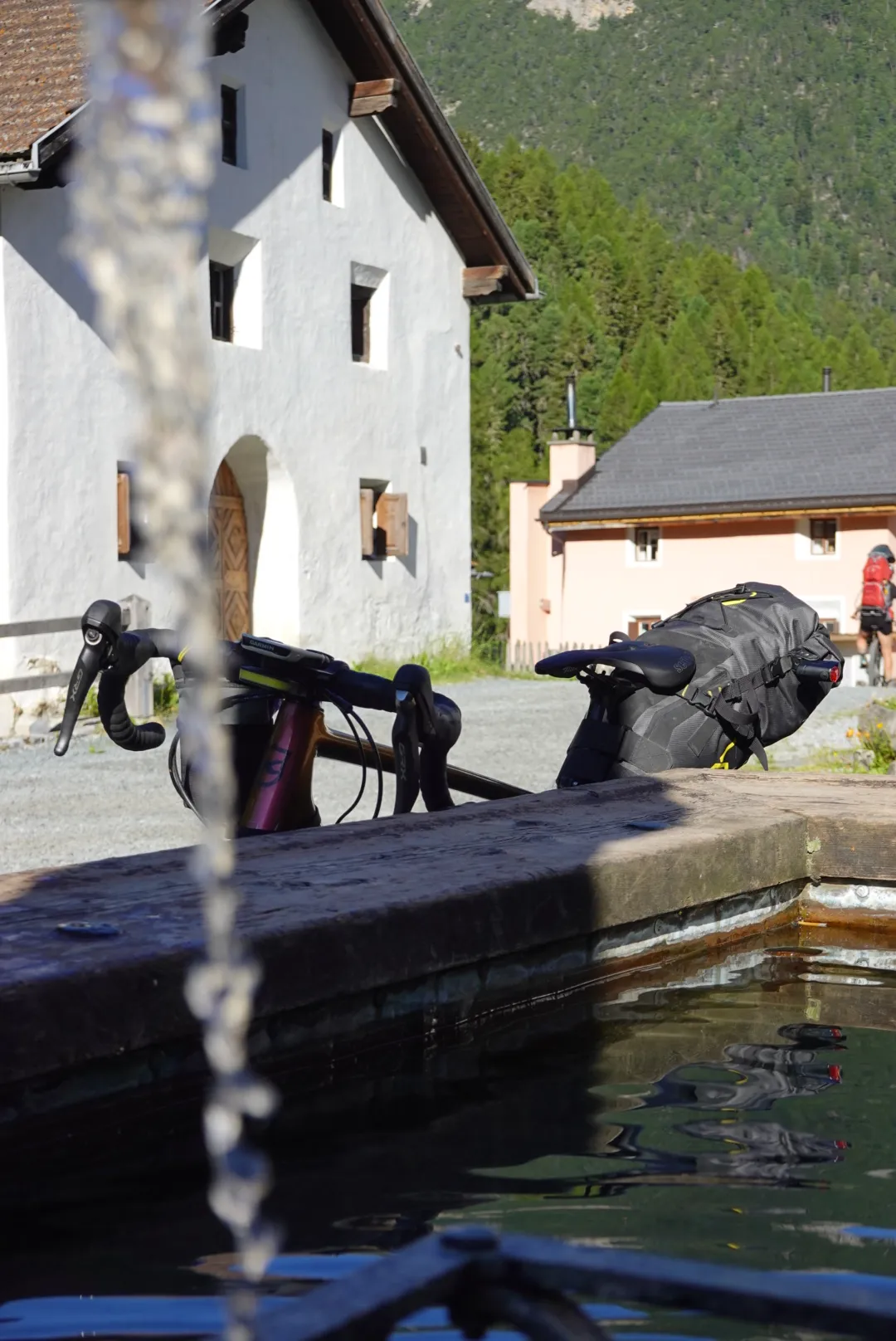 Morning at the village fountain in S-charl, the bike leaning against the trough