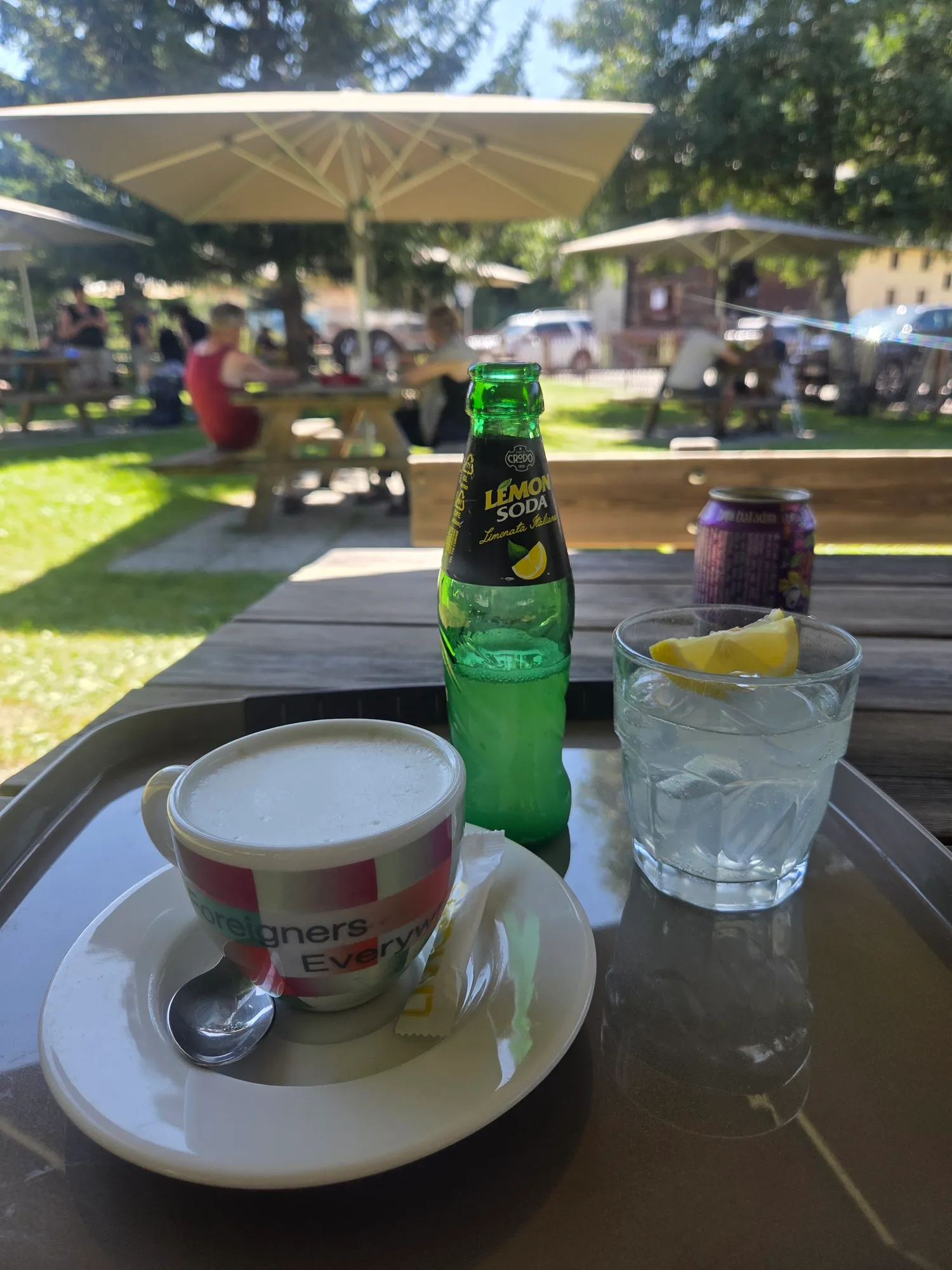 Espresso, Lemonsoda and a glass of water on a terrace table in Livigno