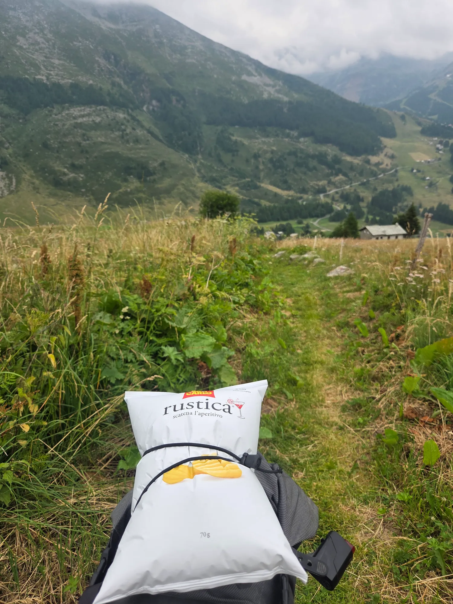 Bag of crisps on the handlebar bag, a narrow meadow path behind