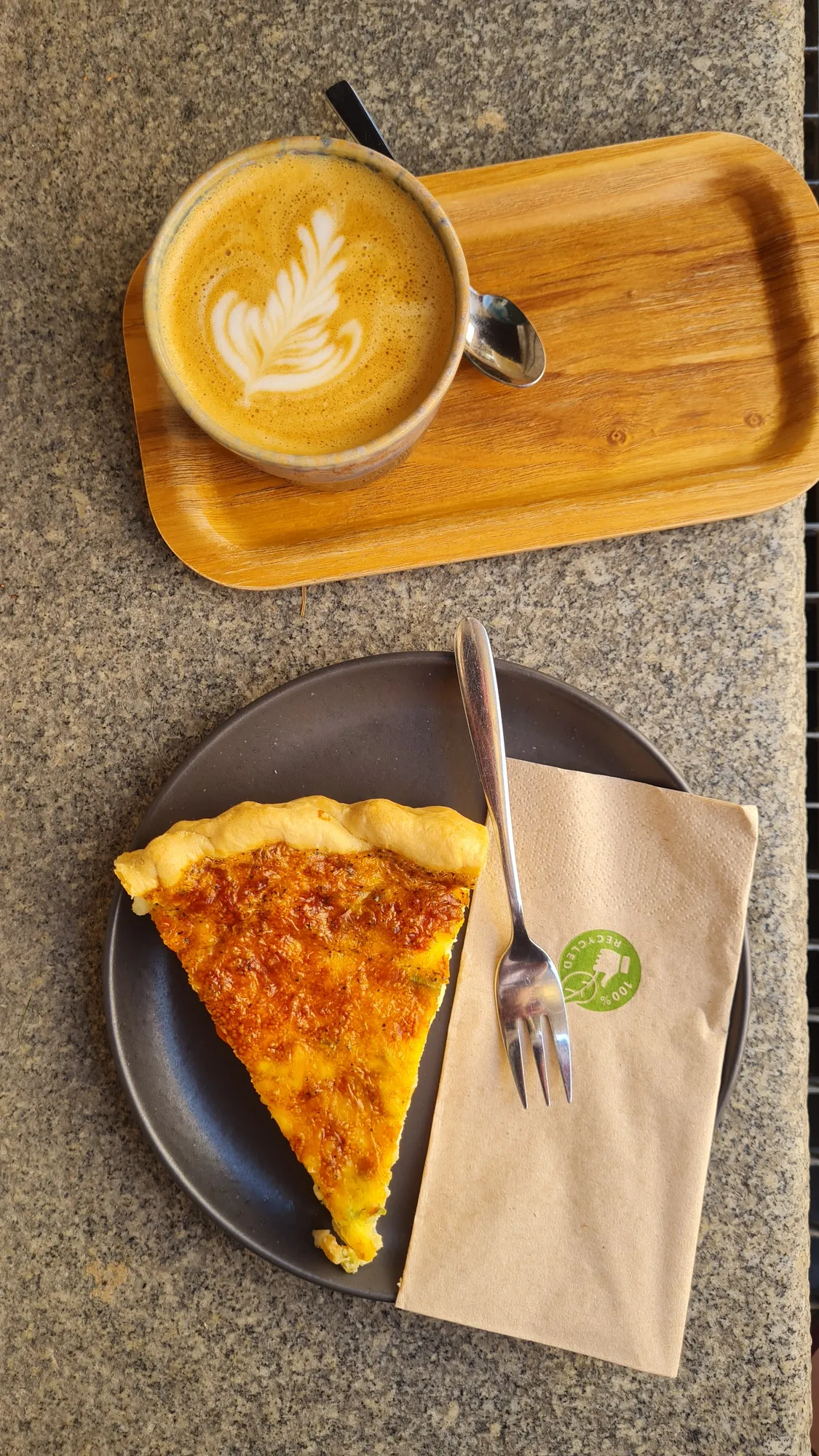 Cappuccino with latte art and a slice of quiche in Salzburg