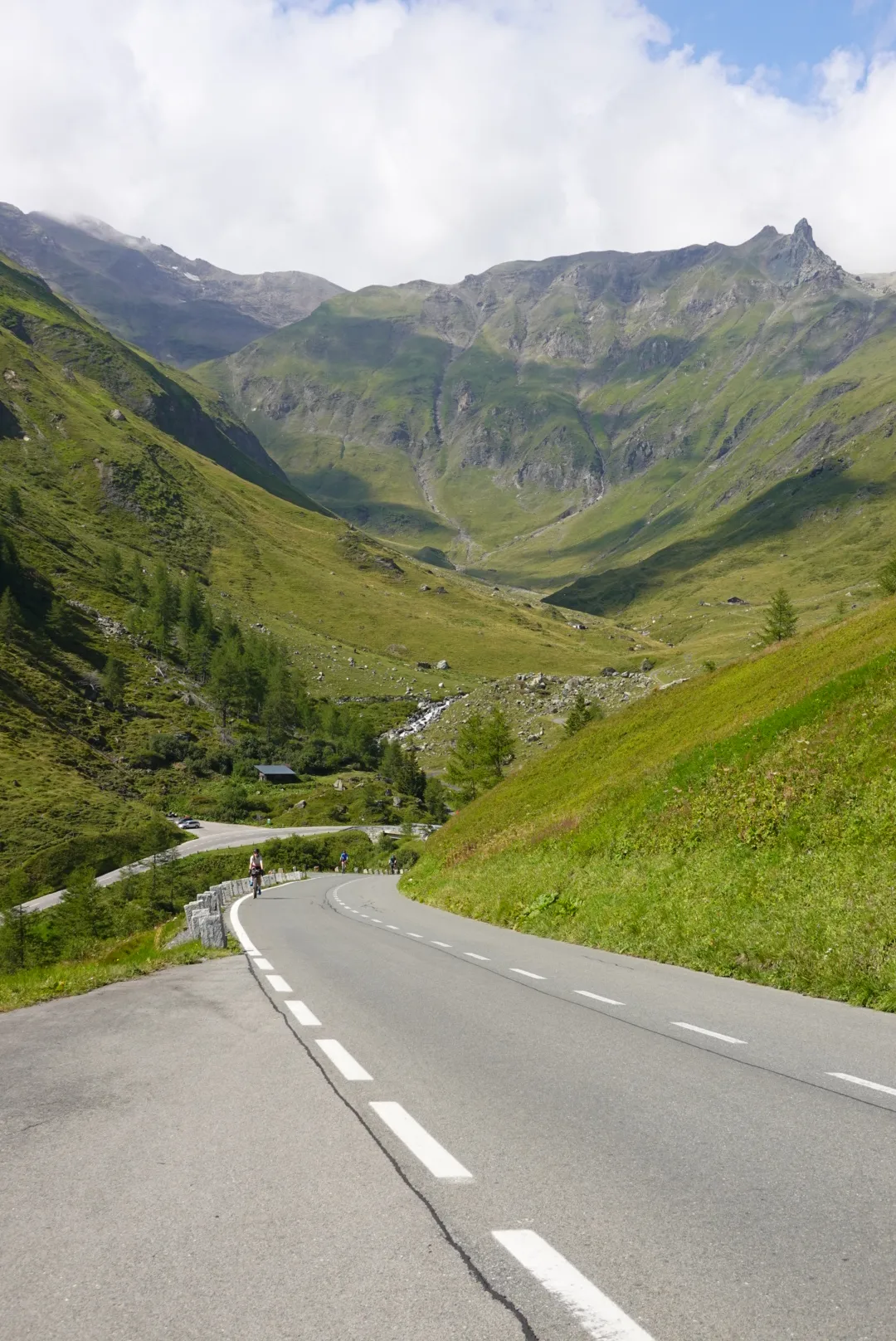 The High Alpine Road climbing through a green high valley