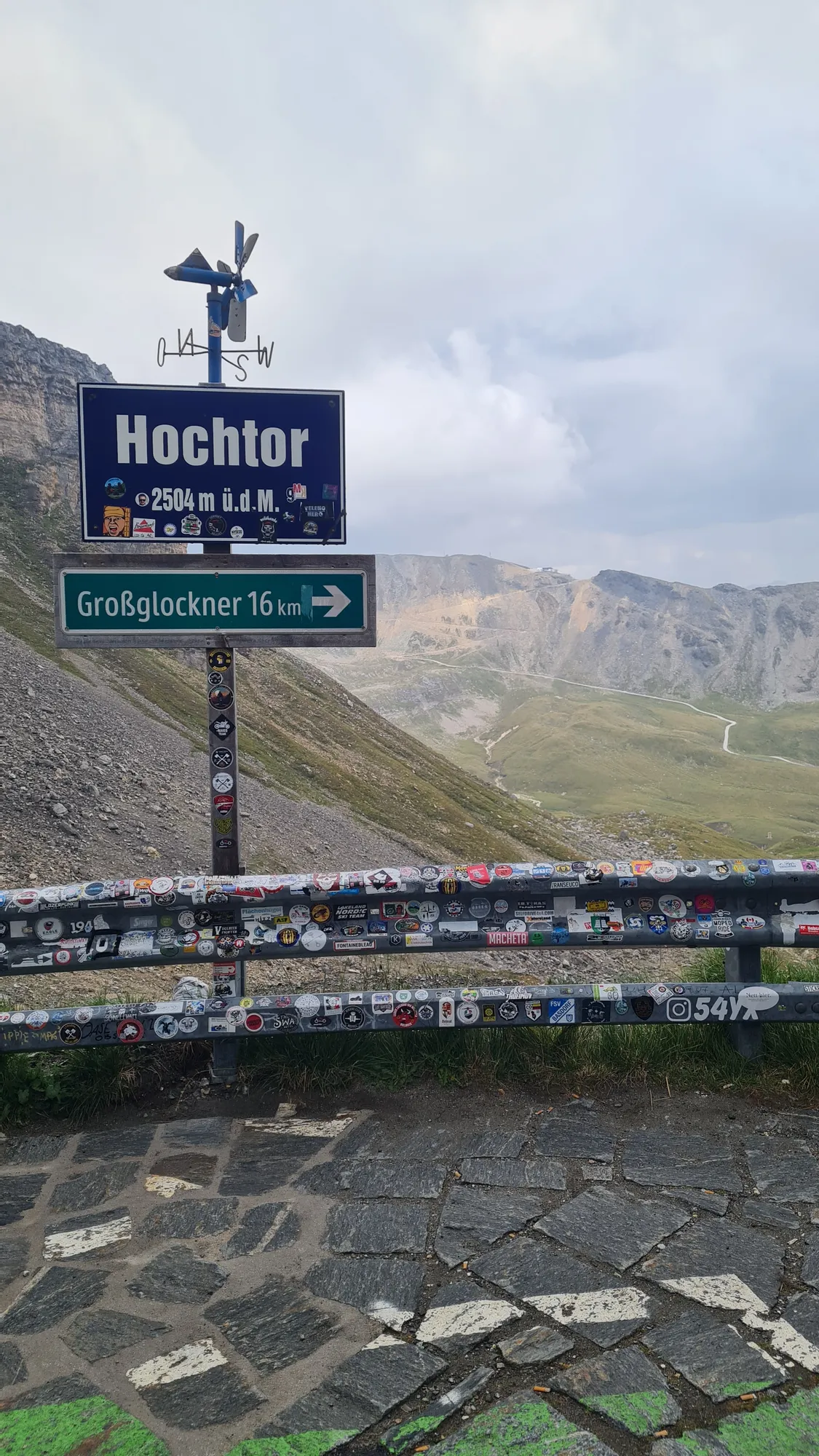 Signpost at the Hochtor under clouds