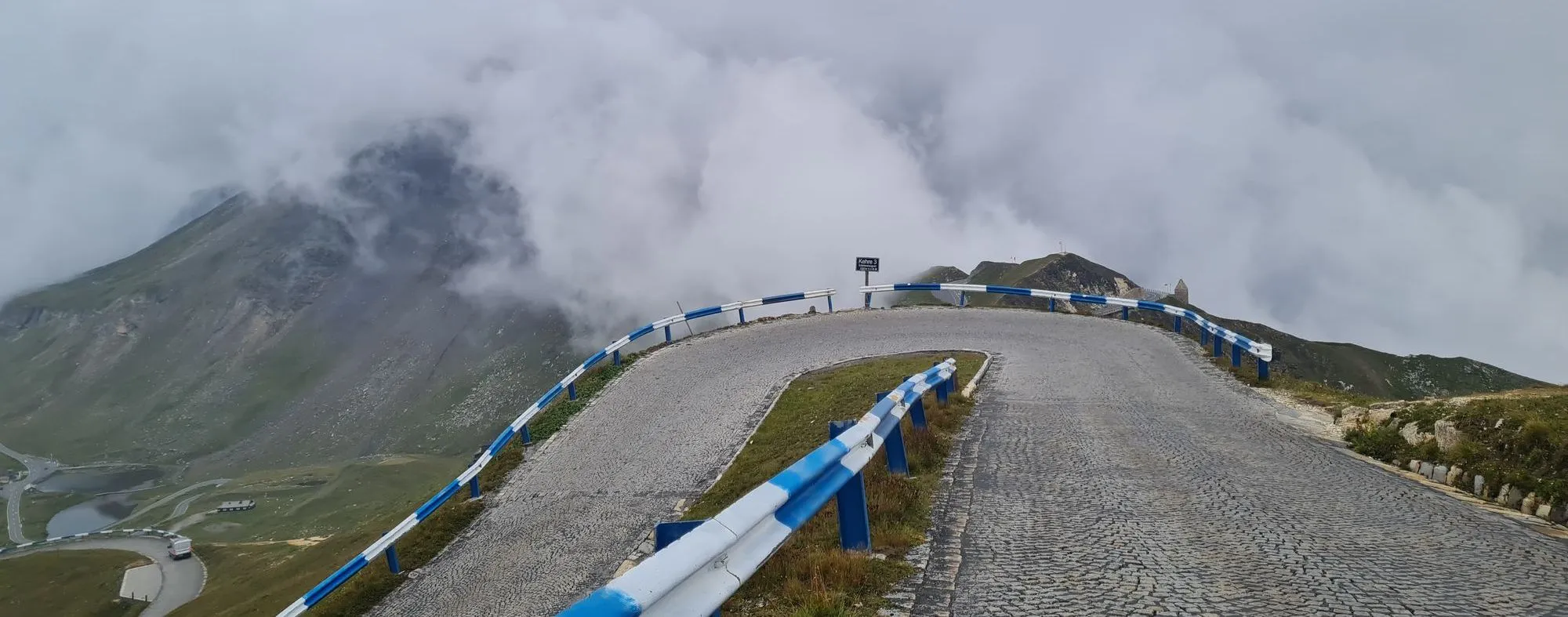Cobbled hairpin up to the Edelweißspitze, thick cloud behind
