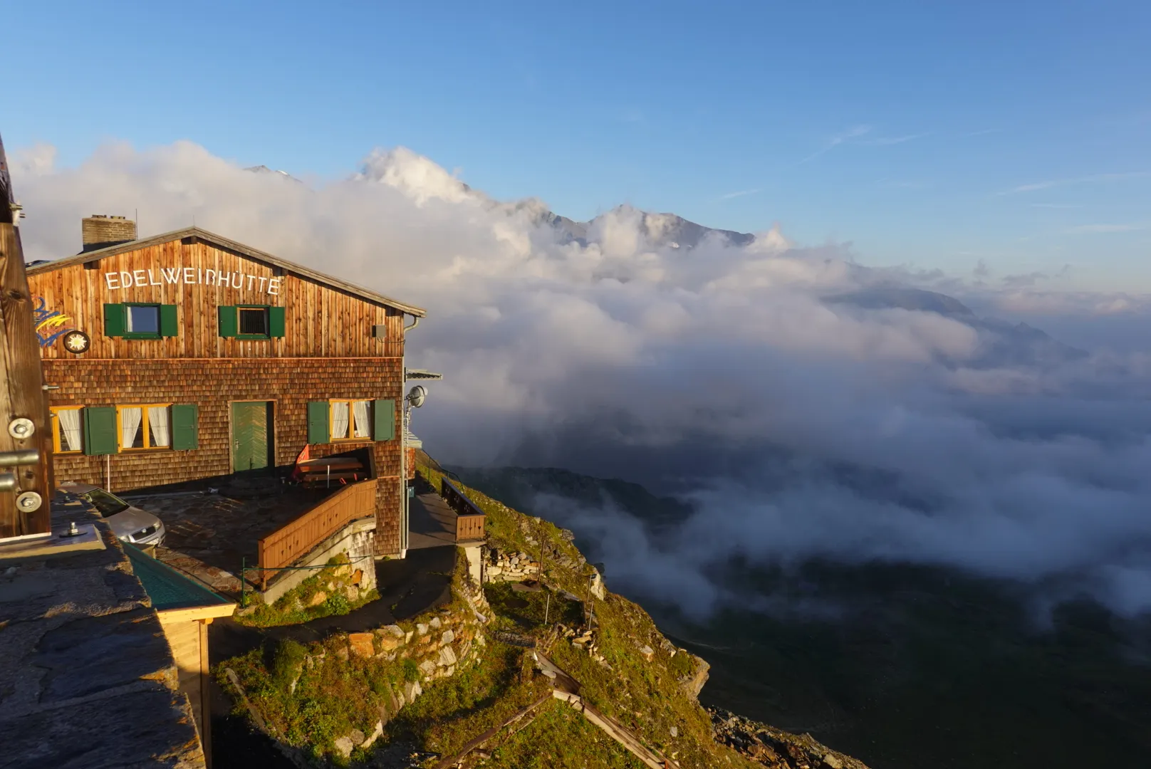 The Edelweißhütte in the first morning light above the clouds