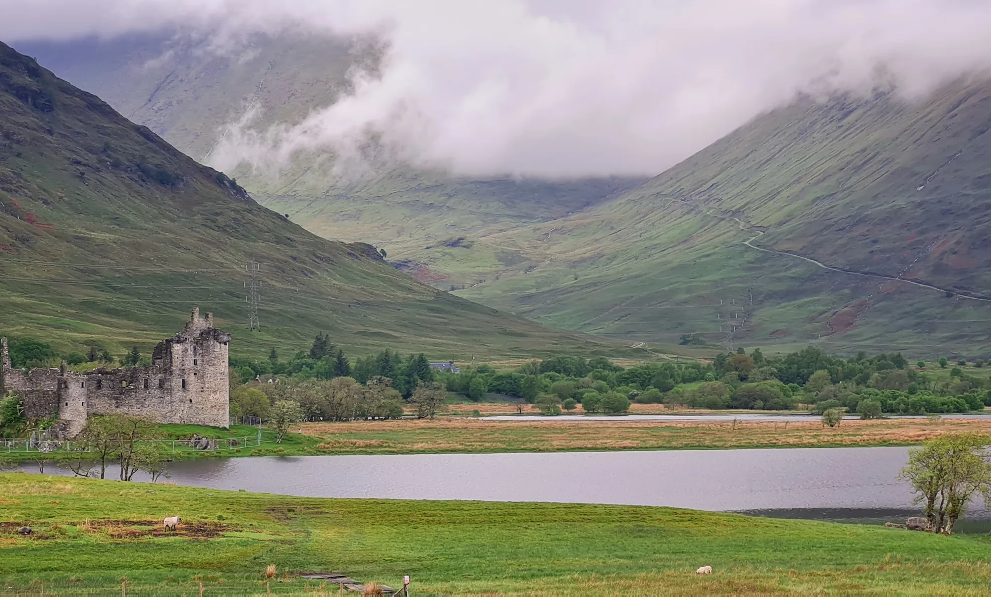 The ruin of Kilchurn Castle on Loch Awe under low clouds