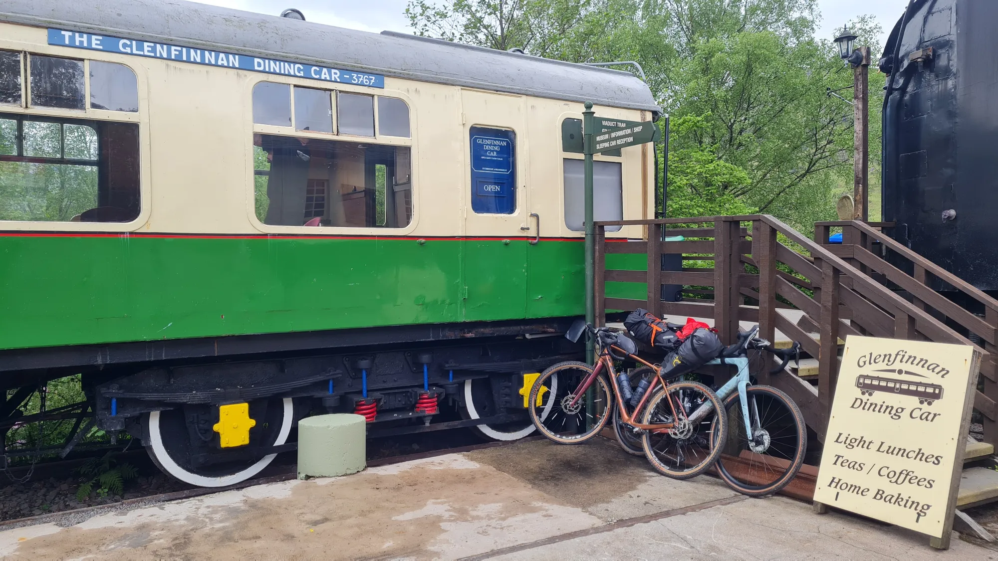 Bikes at the green and cream Glenfinnan Dining Car