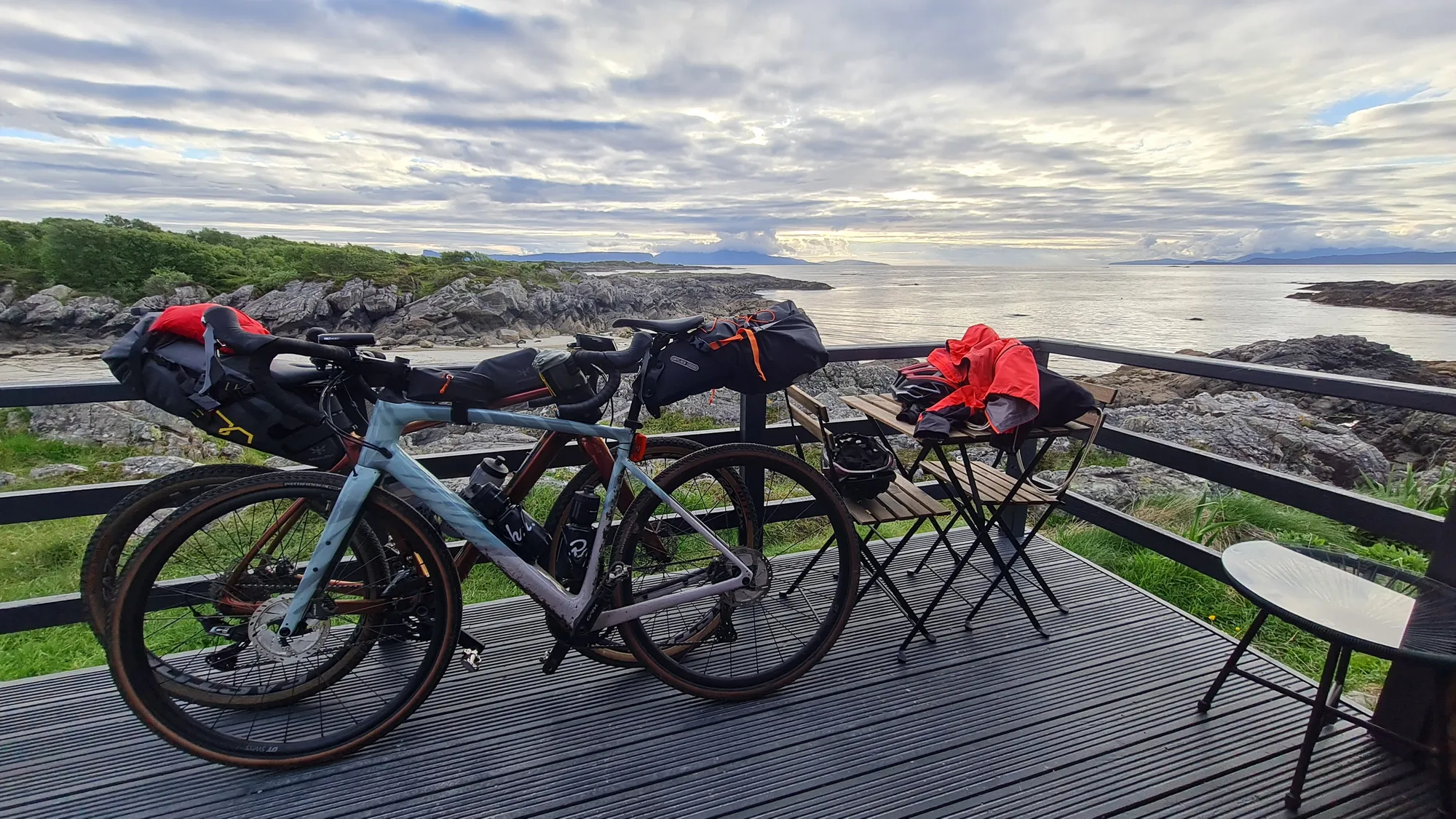 Gravel bikes on the pod's deck overlooking the sea