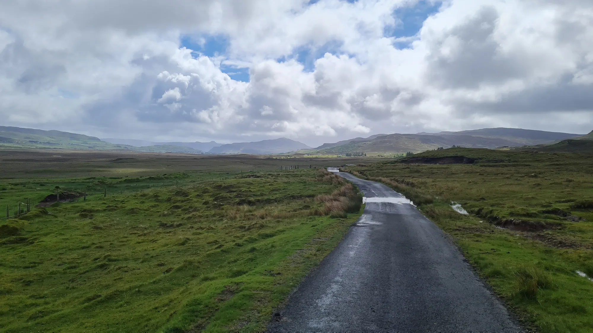 Wet single-track road across the moor on Skye