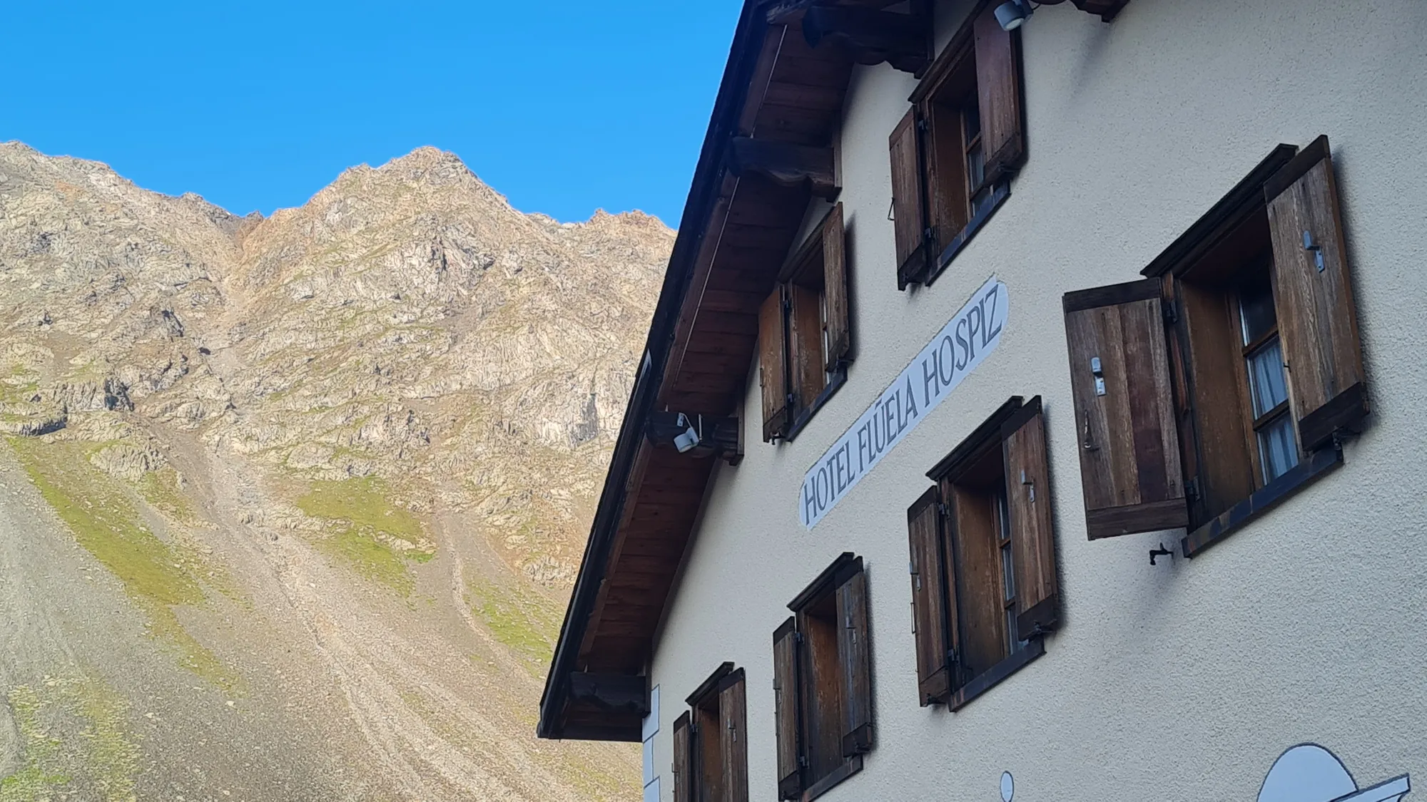 Morning sun on the Flüela Hospiz and its wooden shutters