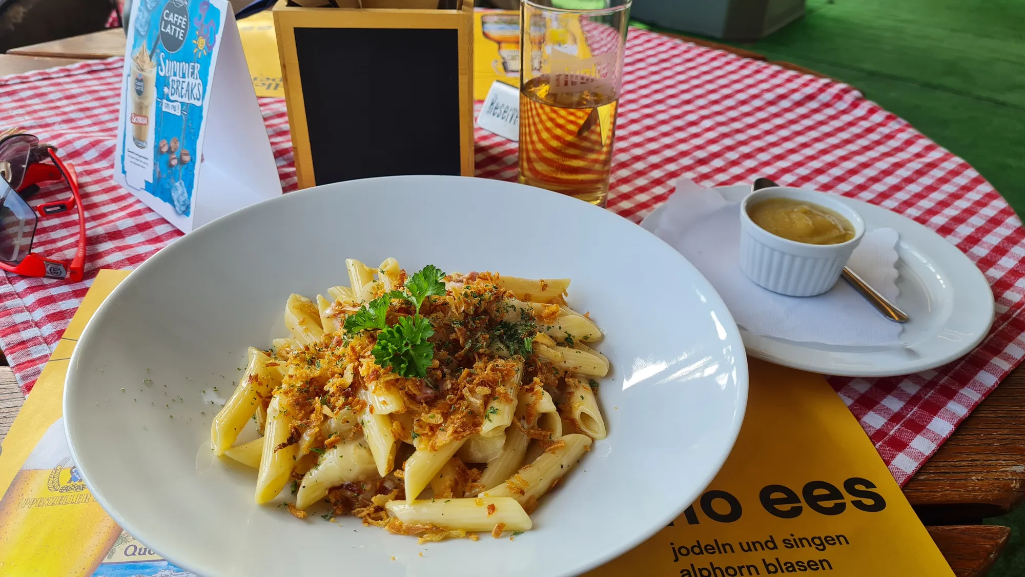 Älplermagronen with apple sauce on a red and white checked tablecloth