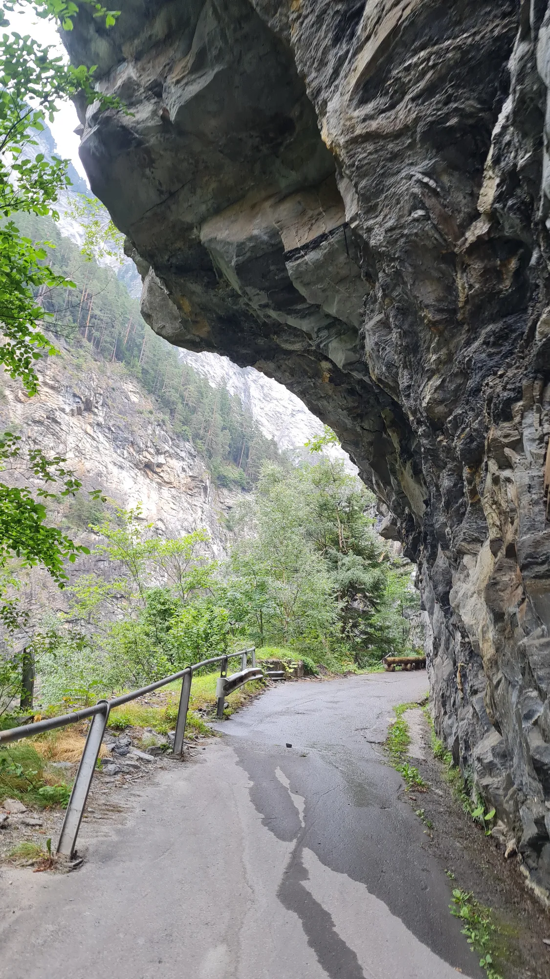 Narrow path beneath overhanging rock in the Viamala gorge