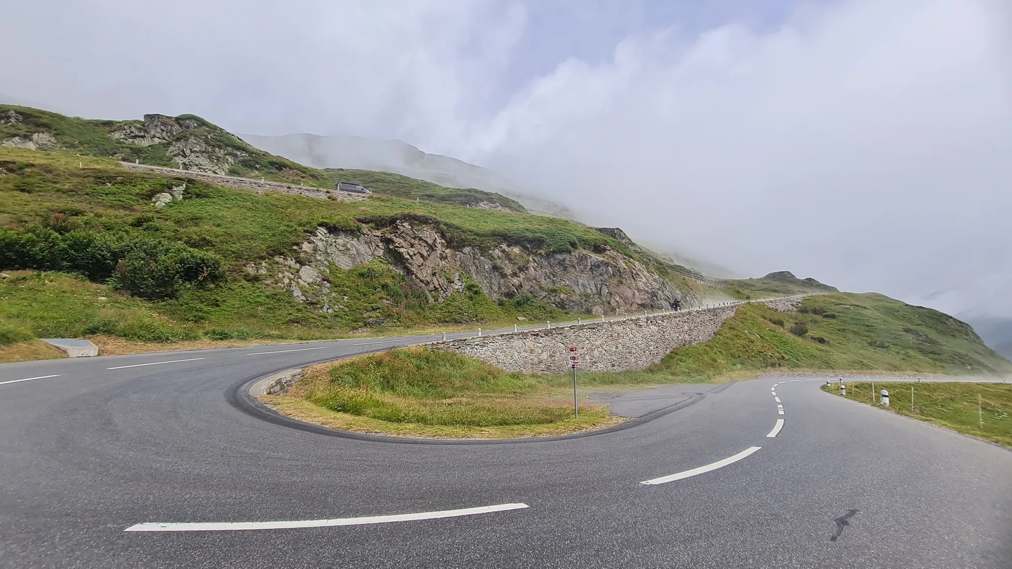 Hairpin on the Oberalppass between low clouds