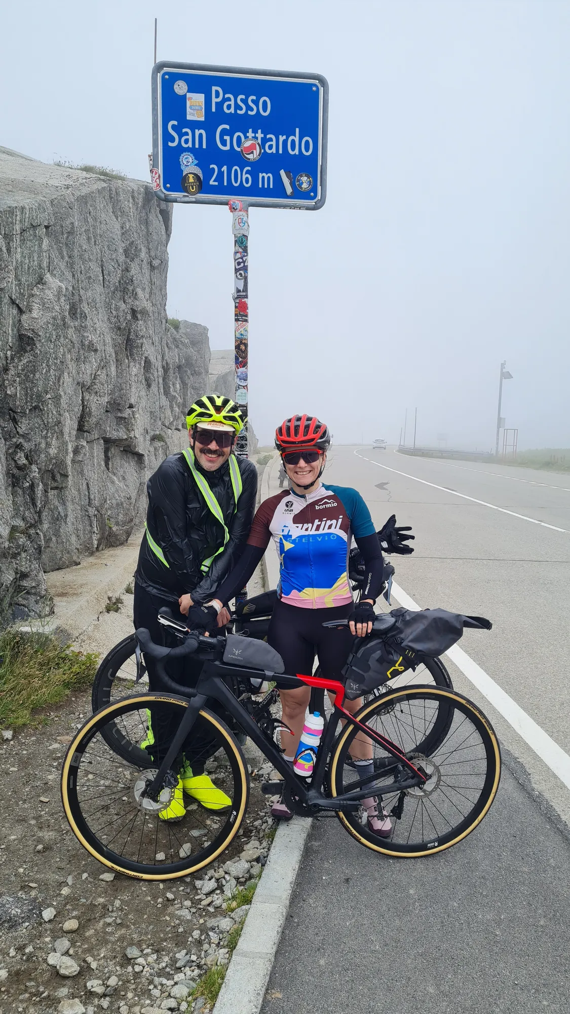 Two of us at the Passo San Gottardo sign, 2106 m, in the fog