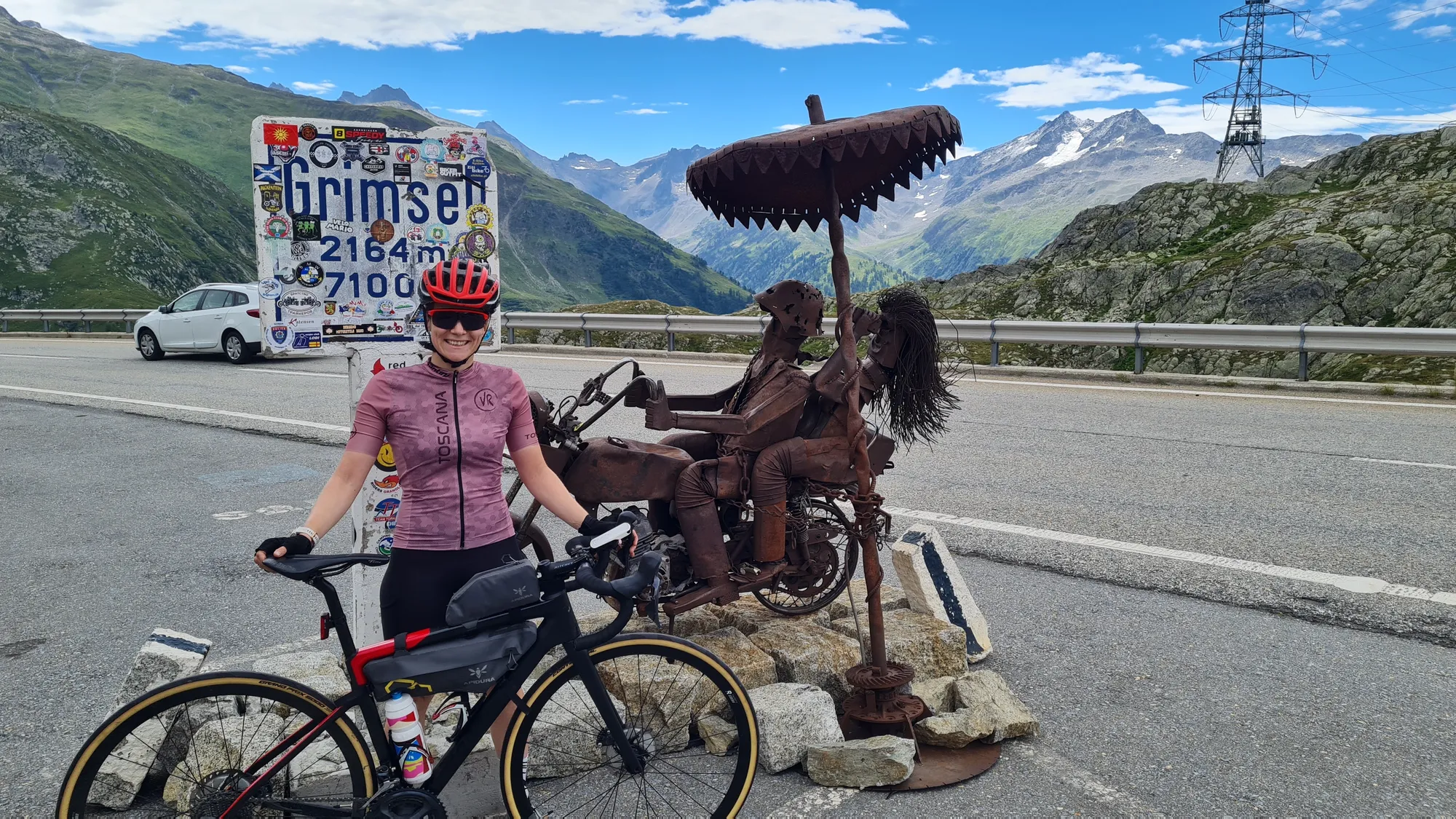 At the Grimselpass sign, 2164 m, next to a metal sculpture